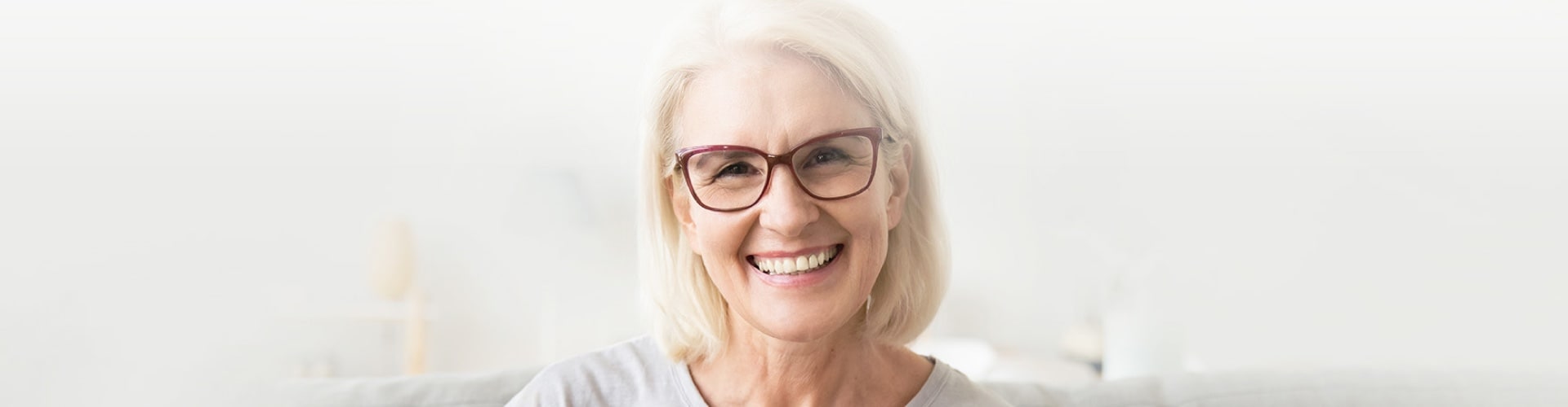 mature woman smiling wearing glasses